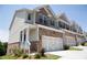 Charming townhome exterior with brick accents, white siding, and attached garages at 339 Cherryhill Ln, Woodstock, GA 30188
