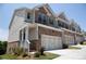 Charming townhome featuring a brick facade and a two-car garage at 339 Cherryhill Ln, Woodstock, GA 30188