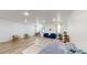 Expansive living area featuring light-colored walls, wood floors, and various furnishings at 339 Cherryhill Ln, Woodstock, GA 30188