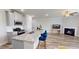 Open concept living and dining featuring granite countertops, stainless appliances, and sleek flooring at 339 Cherryhill Ln, Woodstock, GA 30188