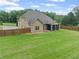 Expansive backyard with lush lawn, screened porch, and privacy fence, ideal for outdoor enjoyment at 108 Donovan Ave, Locust Grove, GA 30248