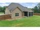 Serene backyard with well-manicured lawn, screened porch, and charming fence creates an inviting outdoor space at 108 Donovan Ave, Locust Grove, GA 30248