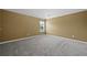 Bright bedroom with neutral walls, a large window and plush gray carpet at 108 Donovan Ave, Locust Grove, GA 30248