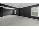 Modern bedroom featuring gray carpet, black accent walls and a large window at 108 Donovan Ave, Locust Grove, GA 30248