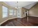 Bright dining room with hardwood floors, fireplace, large windows, and an elegant chandelier at 108 Donovan Ave, Locust Grove, GA 30248