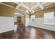 Bright dining room with hardwood floors, coffered ceilings, and a view into the living area at 108 Donovan Ave, Locust Grove, GA 30248