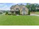 Charming two-story home featuring a well-manicured lawn and beautifully landscaped front yard at 108 Donovan Ave, Locust Grove, GA 30248