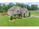 Beautiful two-story home with a well-kept lawn, lush landscaping, and a long driveway at 108 Donovan Ave, Locust Grove, GA 30248