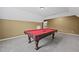 Spacious game room showcasing a pool table with a red felt top at 108 Donovan Ave, Locust Grove, GA 30248