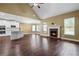 Spacious living room featuring hardwood floors, a fireplace, and an open layout to the kitchen at 108 Donovan Ave, Locust Grove, GA 30248