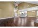 Spacious living room featuring hardwood floors, vaulted ceilings, and open kitchen with stainless steel appliances at 108 Donovan Ave, Locust Grove, GA 30248