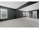 Main bedroom featuring an attached bathroom, large window and gray carpet at 108 Donovan Ave, Locust Grove, GA 30248