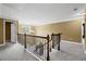 Upstairs hallway landing featuring dark banister and chandelier at 108 Donovan Ave, Locust Grove, GA 30248