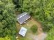 Aerial view of a two-story home featuring a wooden ramp and lush greenery in a secluded setting at 172 White Rose Ln, Temple, GA 30179