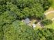 Aerial view showcasing the house nestled among lush green trees and natural landscape at 172 White Rose Ln, Temple, GA 30179