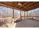 A wood railing surrounds the open back deck, featuring a view of a wooded area at 172 White Rose Ln, Temple, GA 30179