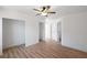 Bedroom features laminate flooring, ceiling fan, and multiple entry doors at 172 White Rose Ln, Temple, GA 30179