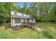 Charming two-story home featuring a wooden ramp, black framed windows, and fresh landscaping, nestled among mature trees at 172 White Rose Ln, Temple, GA 30179
