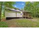 Rear exterior view highlighting the siding, deck, and natural surroundings of the property at 172 White Rose Ln, Temple, GA 30179