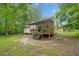 Exterior of house with an inviting covered deck, set in a peaceful, wooded backyard at 172 White Rose Ln, Temple, GA 30179
