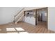 Open-concept living room with hardwood floors, stairway and kitchen view at 172 White Rose Ln, Temple, GA 30179