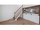Bright living room features open stairs and a pass-through to the modern kitchen at 172 White Rose Ln, Temple, GA 30179