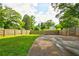 This spacious backyard is fully fenced-in with mature trees and healthy green grass at 2200 Glendale Dr, Atlanta, GA 30032