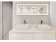 Bright bathroom featuring a double sink vanity with gold faucets and an illuminated mirror at 2200 Glendale Dr, Atlanta, GA 30032
