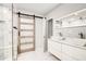 Modern bathroom with double sink vanity, geometric tile shower, and sliding barn door at 2200 Glendale Dr, Atlanta, GA 30032
