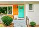 Eye-catching turquoise front door with colorful accents and manicured landscaping at 2200 Glendale Dr, Atlanta, GA 30032