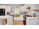Well-lit kitchen featuring white cabinetry, marble countertops, and stainless steel appliances at 2200 Glendale Dr, Atlanta, GA 30032