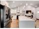 Modern kitchen boasts white cabinets, stainless steel appliances, and a large island with pendant lighting at 2200 Glendale Dr, Atlanta, GA 30032