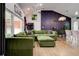 Open-concept living area with green sectional sofa and hardwood floors at 2200 Glendale Dr, Atlanta, GA 30032