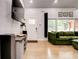 Bright and modern living room with hardwood floors and comfortable green sectional sofa at 2200 Glendale Dr, Atlanta, GA 30032