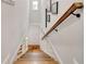 A staircase with a wooden handrail leads downstairs at 2200 Glendale Dr, Atlanta, GA 30032