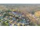 Aerial view in Buford, GA showing the home in a tree-lined neighborhood near a baseball park at 4055 Inman Park Ln, Buford, GA 30519