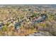 An aerial view in Buford, GA shows the home surrounded by a wooded area and parking lot at 4055 Inman Park Ln, Buford, GA 30519