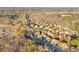 Aerial view in Buford, GA showcasing the home surrounded by a wooded neighborhood and parking area at 4055 Inman Park Ln, Buford, GA 30519