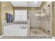 Beautiful bathroom showcasing a tub with tile surround and a glass-enclosed shower at 4055 Inman Park Ln, Buford, GA 30519