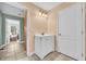 Well lit bathroom with a pedestal sink and neutral colors at 4055 Inman Park Ln, Buford, GA 30519
