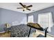 Bedroom with blue walls, a bed, treadmill and dual windows at 4055 Inman Park Ln, Buford, GA 30519
