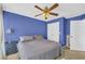 Bedroom featuring blue walls, gray bed, and dual closets at 4055 Inman Park Ln, Buford, GA 30519