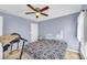 A comfy bedroom features a ceiling fan and neutral tones at 4055 Inman Park Ln, Buford, GA 30519