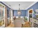 Elegant dining room featuring a wooden table set, chandelier, and windows with lovely patterned drapes at 4055 Inman Park Ln, Buford, GA 30519