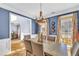 Lovely dining room with a chandelier, a wooden table set, and large windows providing lots of natural light at 4055 Inman Park Ln, Buford, GA 30519