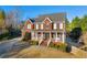 Charming two-story home with a covered front porch, perfect for enjoying the outdoors at 4055 Inman Park Ln, Buford, GA 30519