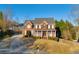 Inviting two-story brick home with a charming front porch and well-manicured landscaping at 4055 Inman Park Ln, Buford, GA 30519
