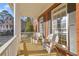 Cozy front porch with white wicker furniture at 4055 Inman Park Ln, Buford, GA 30519