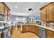 Spacious kitchen featuring wooden cabinets, stainless steel appliances, and hardwood floors at 4055 Inman Park Ln, Buford, GA 30519