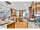 Bright kitchen featuring wooden cabinets, granite counters, stainless steel appliances, and an open view at 4055 Inman Park Ln, Buford, GA 30519